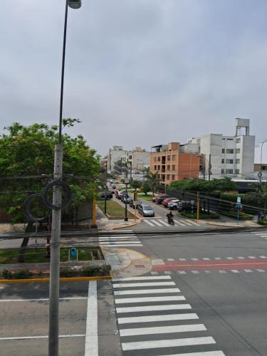 an empty street with a crosswalk in a city at LAS ARTES INN in Lima