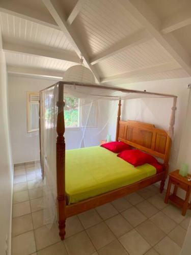 a bedroom with a canopy bed in a room at Villa coco in Bouillante