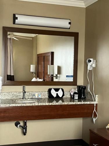 a bathroom with a large mirror and a sink at Comfort Inn & Suites Ocean Shores in Ocean Shores