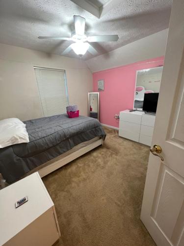 a bedroom with a bed and a ceiling fan at Home sweet home in Columbus