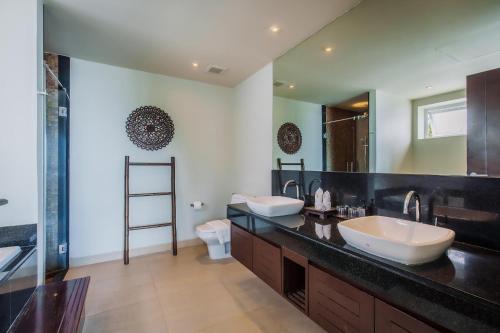 a bathroom with two sinks and a large mirror at Daisy 2 Bed Amazing Seaview in Rawai Beach