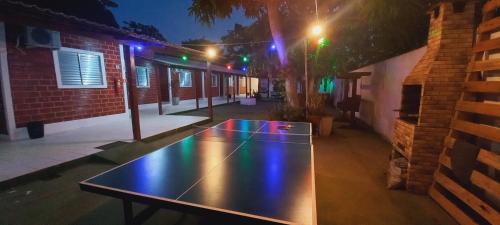 a ping pong table in a courtyard at night at Pousada Angatu alter in Alter do Chao