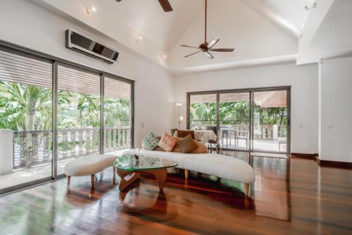 a living room with a couch and a table at Orchid Pool Villa in Rawai in Rawai Beach