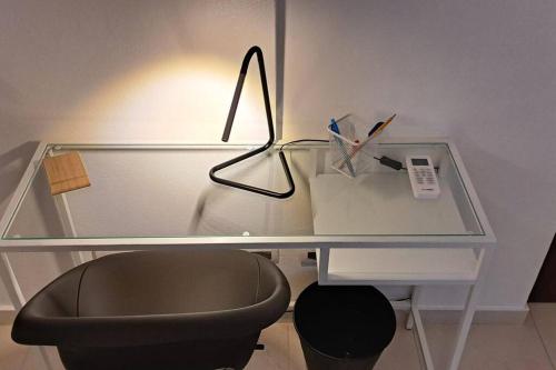 a glass desk with a chair and a glass table at Deluxe villa with jacuzzi and beautiful garden in Santiago de los Caballeros