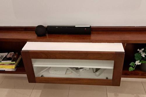 a wooden table with a tv on top of it at Deluxe villa with jacuzzi and beautiful garden in Santiago de los Caballeros