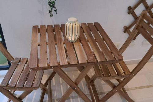 a wooden table and chair with a lamp on it at Deluxe villa with jacuzzi and beautiful garden in Santiago de los Caballeros