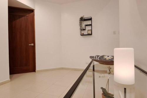a room with a hallway with a table and a door at Deluxe villa with jacuzzi and beautiful garden in Santiago de los Caballeros