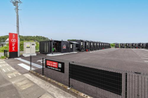 a parking lot with a row of black containers at HOTEL R9 The Yard Satsumasendai in Satsumasendai