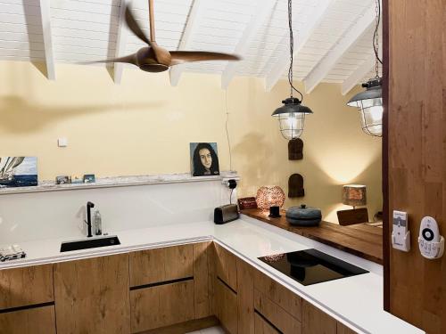 een keuken met een plafondventilator en een wastafel bij Villa CECILIA in Oyster Pond