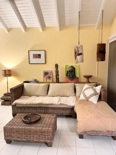 a living room with two couches and a table at Villa CECILIA in Oyster Pond