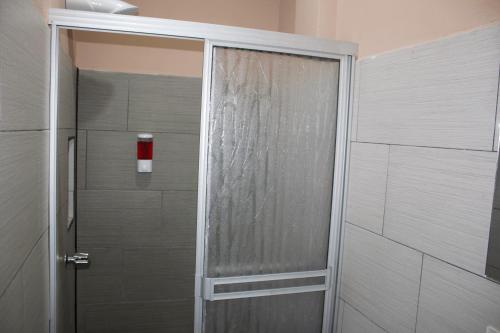 a shower with a glass door in a bathroom at Hotel La Castella in San José