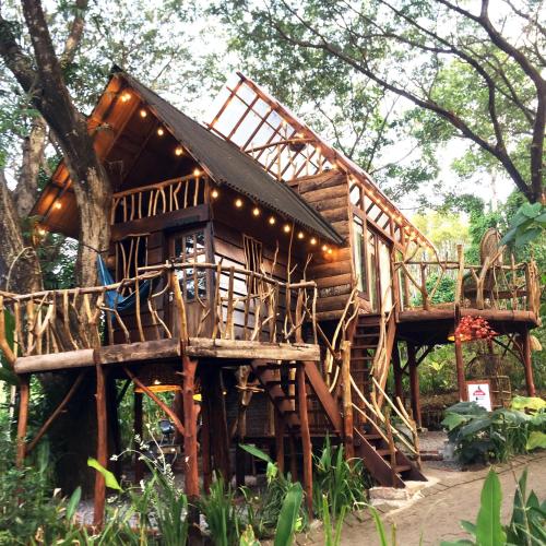 a tree house with lights on top of it at Uma Villa Manado in Manado