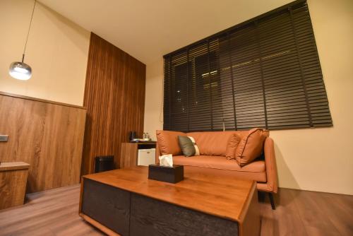 a living room with a couch and a table at Two Couples Leisure Art Motel in Tainan