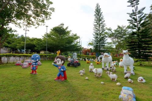 a group of toy figures in a field with sheep at เขาค้อออฟเลิฟ in Khao Kho