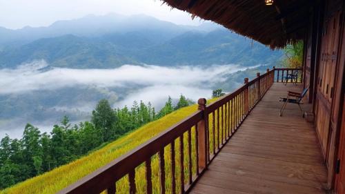 a balcony of a house with a view of the mountains at Lagom Su Phi Retreat in Hoàng Su Phì