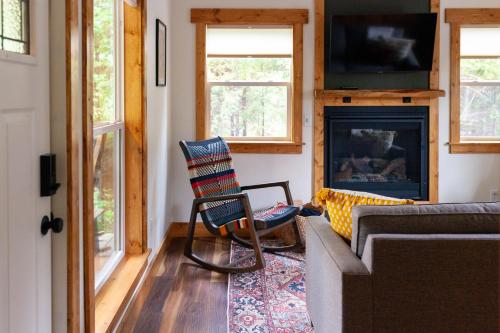 a living room with a couch and a fireplace at Backwoods Cabins in Carson