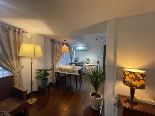 a living room with a dining table and a kitchen at Mận Đào Villa in Ho Chi Minh City