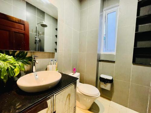 a bathroom with a sink and a toilet at Ule Home in Ho Chi Minh City