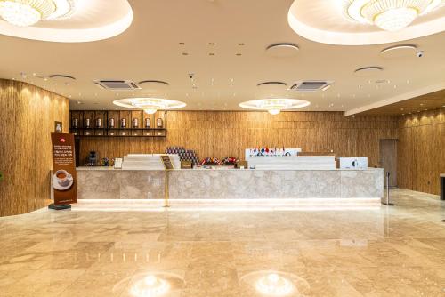 a lobby of a restaurant with a counter at Hotel The Grang Seogwipo in Seogwipo