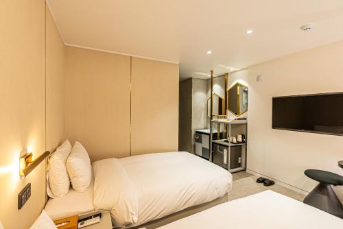 Voodi või voodid majutusasutuse Hotel The Grang Seogwipo toas
