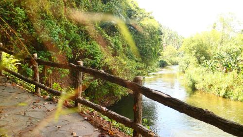 a fence next to a river next to a river at Uma Villa Manado in Manado