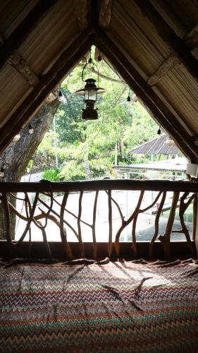 a view of a window in a building with a lamp at Uma Villa Manado in Manado