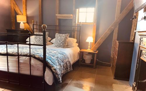 a bedroom with a bed and a window at Spacious Cabin with Private Hot Tub, and Private Pool, in 5 Acres - intimate Special stay For 2 Adults - plus 1 child under 2 and up to 2 dogs stay for free in Downham
