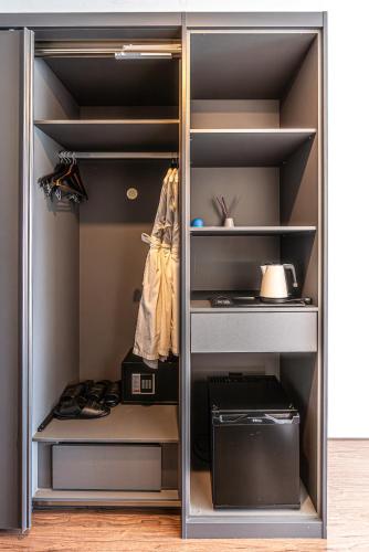 a walk in closet with a door open with shoes at Hotel The Grang Jungmun in Seogwipo