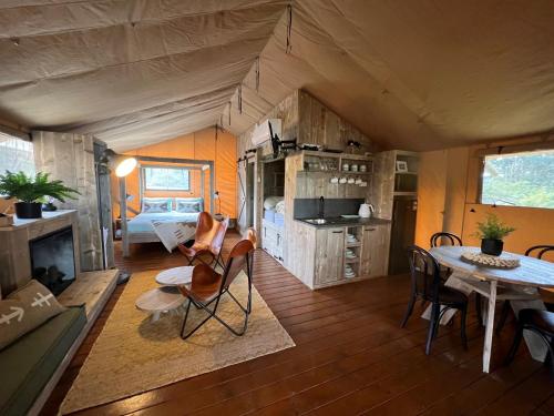 a living room and dining room of a tiny house at NRMA Port Arthur Holiday Park in Port Arthur