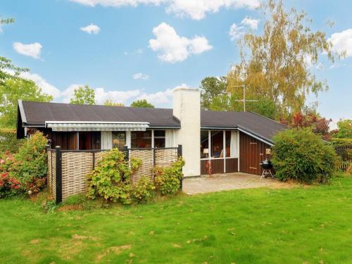 a house with a fence in front of a yard at 4 person holiday home in Frørup-By Traum in Frørup