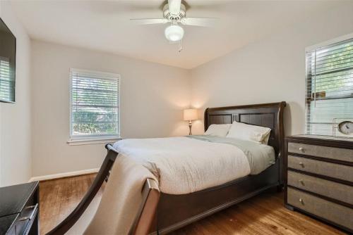 a bedroom with a bed and a ceiling fan at Elegant 3BR Bungalow Oasis plus Pool in Prime Locations in Houston