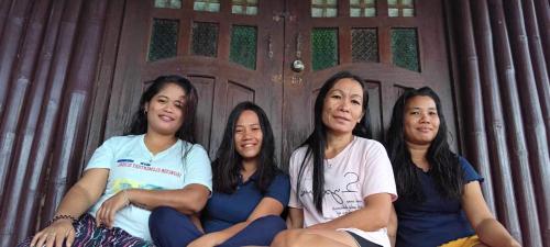 a group of women sitting in front of a door at Sanctuaria Treehouses Busuanga in Busuanga