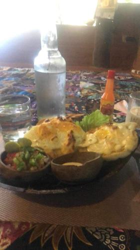 a table with a plate of food on a table at Sanctuaria Treehouses Busuanga in Busuanga