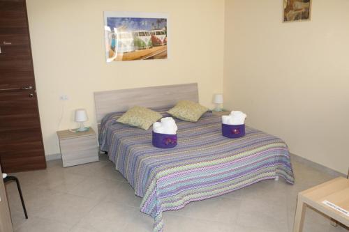 a bedroom with a bed with two towels on it at B&B Karisma e apartment in LʼAquila