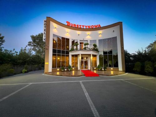 a building with a red rug in front of it at Bursztynowa in Łuków