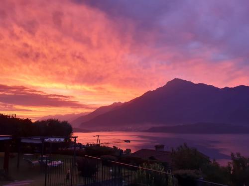 a sunset over a body of water with a mountain at Ca' del Barba in Domaso