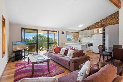 a living room with a couch and a table at Sand Dunes in East Ballina