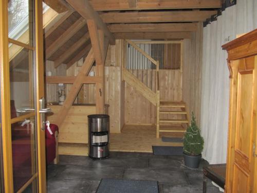 a large room with a staircase in a house at Ferienwohnung Hägelhof in Naila