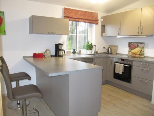 a kitchen with a counter and a stove top oven at Ferienwohnung Hägelhof in Naila