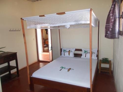 a bunk bed with a white canopy in a room at PermaKite in Andovokonko