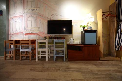 a living room with a tv and a table and chairs at Sweet Heart B&B in Jian