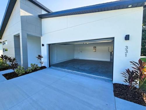 an empty garage in a white building at Spacious Modern 4bd 2ba Home! Close to LEGOLAND in Winter Haven