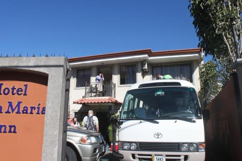 a white truck parked in front of a building at Hotel Santa Maria Inn in Alajuela City