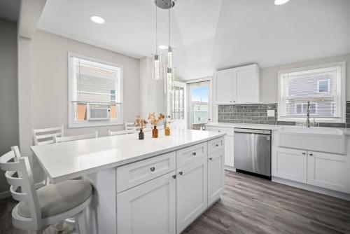 a kitchen with white cabinets and a white counter top at Full House 2 Blocks from Beach in Brigantine