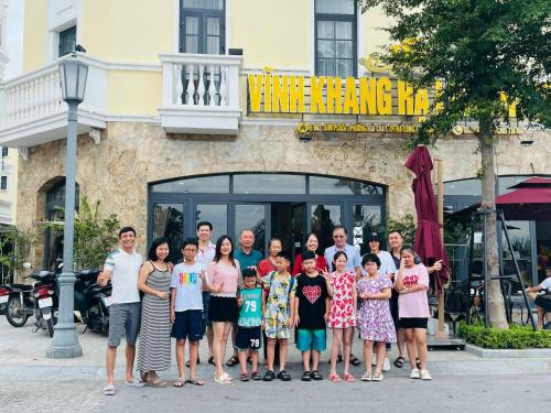 a group of people posing for a picture in front of a building at VĨNH KHANG HẠ LONG HOTEL in Ha Long
