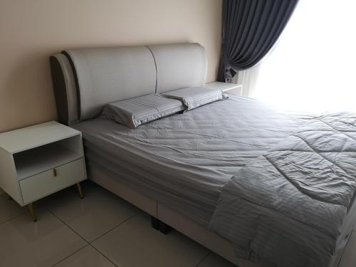 a bedroom with a bed and a window at Metropol Suite in Bukit Mertajam