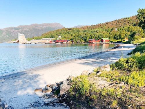 a beach with a body of water and some houses at 8 person holiday home in averøy-By Traum in Averoy