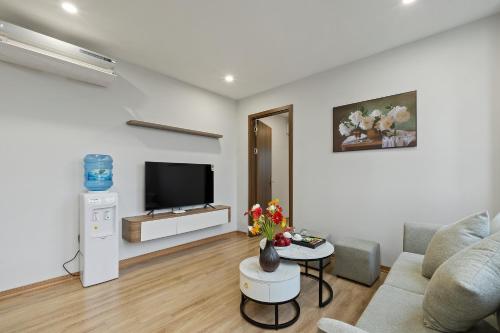 a living room with a couch and a tv at 22housing Residence Suites in Hanoi