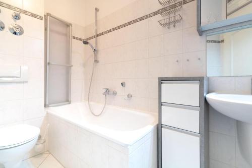 a white bathroom with a sink and a toilet at Villa Eden Binz Typ 2 / Apartment 3 in Binz