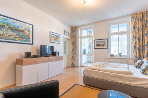 a bedroom with a bed and a tv in it at Villa Eden Binz Typ 2 / Apartment 3 in Binz